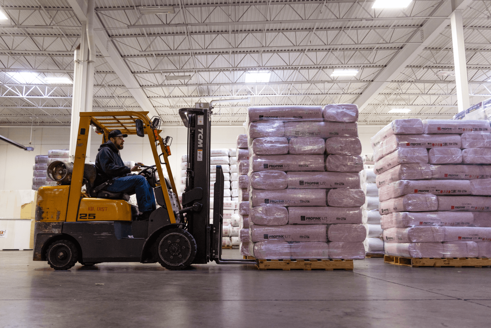 Warehouse employee driving a forklift